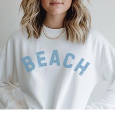 🌊 BEACH heavy blend crewneck sweatshirt ⛱️ Ribbed knit collar to retain shape after washing  🐚 No itchy side seams  🩴 Medium-heavy fabric blend 50% cotton / 50% polyester  🌴 Classic fit and crew neckline for comfy wearing experience with a clean-cut style 🏄🏽 No itchiness thanks to the gray, pearlized tear-away label 🦑 100% ethically grown US cotton  🪷 Available in colors: white, sand sport gray and dark heather SIZING:: * Sizing is unisex so runs like men's, however not overly large * Mo Trendy Crew Neck Sweater For Beach, White Crew Neck Sweater For Beach, Oversized Crew Sweatshirt For Summer, Beach Cotton Crew Neck Sweatshirt, Trendy Crew Neck Sweatshirt For Beach, Casual Crew Neck Sweatshirt For Beach Season, Cotton Sweatshirt With Letter Print, Blue Crew Neck Sweatshirt For Beach Season, Vacation Crew Neck Sweater For Beach Season