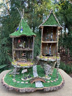 two bird houses made out of wood and moss