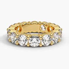 a yellow gold ring with five round cut diamonds