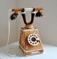 an old fashioned phone is made out of gingerbread and decorated with chocolate icing