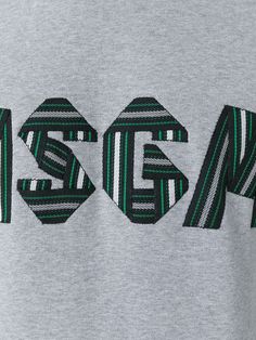 the back of a grey sweatshirt with green and black letters that spell out ssg