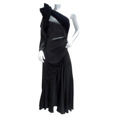 Introducing the Lanvin Haute Couture 1980s Velvet Bias Cut Black Gown, a breathtaking masterpiece that epitomizes timeless elegance and sophistication. This incredible gown showcases Lanvin's signature craftsmanship and attention to detail, making it a true statement piece. Crafted from luxurious black velvet, the gown features a bias cut that elegantly drapes and flares out at the bottom, creating a flattering silhouette that exudes grace and poise. The asymmetric one-sleeve style adds a modern Vintage Silk Party Gown, Vintage Silk Gown For Formal Occasions, Vintage Floor-length Evening Gown, Vintage Evening Gown With Bias Cut, Vintage Bias Cut Evening Gown, Vintage Silk Evening Dress For Gala, Vintage Silk Evening Dress, Vintage Evening Dress For Cocktail, Vintage Cocktail Evening Dress