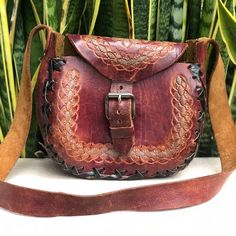 Brown Tooled Leather Stitched Floral Handbag Purse Bag Flower Cross X Body Saddle Bag Satchel Vintage 70s 80s Vtg 1970s 1980s Buckle Flap Closure. Tooled Details Throughout Bag. Unlined. Measurements Are Approximate: Height - 7.5” (Not Including Strap) Width - 9” Depth - 4” (At Widest Part) Scuffs And Wear. See Pictures For Additional Details Of Condition. Smoke Free Home. Retro Leather Saddle Bag, Retro Hand-tooled Bags, Retro Hand-tooled Bag For Everyday Use, Retro Hand Tooled Bag For Everyday Use, Retro Hand Tooled Bag, Vintage Hand-tooled Pouch Bag, Vintage Soft Leather Saddle Bag, Retro Rectangular Festival Bag, Vintage Crossbody Shoulder Bag For Festival