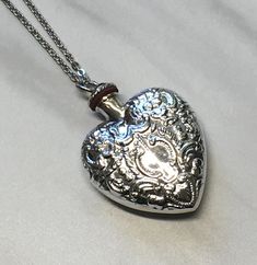 This is a Sterling silver hollow pendant necklace.  The top screws off and the cavity can hold perfume, ashes, sand, essential oil or anything that you want close to you.  It measures 40mm in height and 30mm wide and weighs approx. 12.5 grams.  Comes on a silver plated cable chain that you can pick the length .  Free shipping through USPS First class mail. Silver Etched Necklace For Valentine's Day, Valentine's Day Silver Etched Necklace, Silver Heart Locket Necklace Spiritual Style, Spiritual Silver Locket Necklace For Memorial, Spiritual Silver Locket Necklace For Anniversary, Spiritual Silver Heart Pendant Locket Necklace, Heart Perfume, Essential Oil Necklace, Perfume Necklace