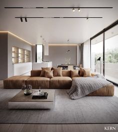 a living room with large couches and lots of windows on the side of it