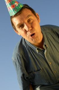 a man wearing a party hat making a funny face