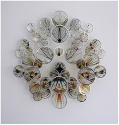 a clock made out of glass sitting on top of a wall