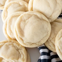 a pile of cookies sitting on top of a white table next to a black and white striped towel