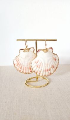 These beautiful earrings are made from real gold plated scallop shells. The seashells are around 50mm long ear-wires on these earrings gold plated with 22k gold. Each shell is unique, therefore, please expect a small variation from the shells on the photographs. Each item is carefully packaged in a beautiful jewellery box ready as a gift. If you would like to add a personalized note with your order, just write a note at checkout and I will send a small card with your gift to the recipient. If you need a bigger quantity or any customized jewellery for your very special occasion (birthdays, weddings, bridal showers or any other event), please send me a message and I'll be glad to help. Gold Shell As Summer Gift, Gold Shell Earrings For Summer, Gold Shell For Summer Gift, Gold Shell Earrings With Ear Wire As Gift, Ocean-inspired Gold Jewelry With Ear Wire, Elegant Shell Earrings With Ear Wire, Gold Shell Earrings With Ear Wire For Gift, Gold Shell Ear Wire Gift, Gold Shell-shaped Jewelry For Summer