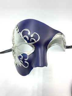 This is a stunning half face phantom masquerade mask with very venetian and phantom design embellishments, The mask has navy blue color in the middle decorated with distressed silver.It has a very elegant mysterious look. In my store I have other half face masquerade masks that you might like and laser cut masks with different colors and designs and different color of gems. I also have machine embroidered masquerade masks that color of threads and gems can be changed, I have masks with stick and Blue Masquerade Mask For Halloween, Blue Halloween Masquerade Mask, Silver Eye Mask For Theater, Blue Venetian Masks For Masquerade, Silver Theater Eye Mask, Venetian Silver Eye Mask, Blue Venetian Eye Mask, Blue Venetian Masquerade Mask, Masquerade Mask Aesthetic Male