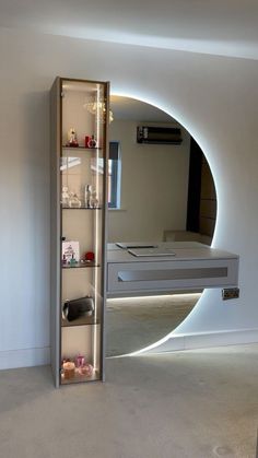 a room with a mirror and shelves in it