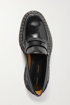 Find PROENZA SCHOULER Lug Sole Glossed-leather Platform Loafers on Editorialist. Proenza Schouler elevates the classic penny loafers with this chunky platform pair that are outlined with topstitching and lugged to ensure traction. They're made from glossed-leather and have serrated trims along the tongues. Wear yours with tailored shorts or skirts. Luxury Leather Work Shoes With Vibram Sole, Luxury Leather Shoes With Vibram Sole For Work, Black Platform Loafers With Stitched Sole For Formal Occasions, Luxury Loafers With Vibram Sole And Round Toe, Designer Platform Loafers With Leather Sole For Formal Occasions, Formal Slip-on Platform Loafers With Vibram Sole, Black Loafers With Vibram Sole For Work, Luxury Leather Shoes With Stitched Sole For Work, Black Loafers With Vibram Sole For Office