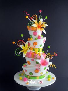 a multi - tiered cake decorated with flowers and music notes