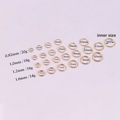 various sizes and shapes of rings on a white surface with measurements for each ring size