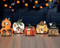 a group of pumpkins sitting on top of a wooden floor