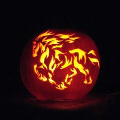 a carved pumpkin with horses on it