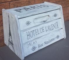 a white wooden box with the word hotel de lavenir painted on it's side