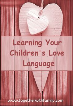 a heart hanging on a wooden fence with the words learning your children's love language