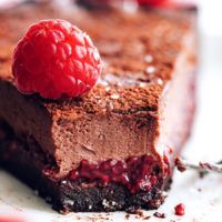 a piece of chocolate cake with raspberries on top