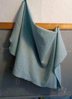 a folded blue cloth hanging on the wall