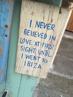 a wooden sign that says i never believed in love at first sight until i went to ibiza