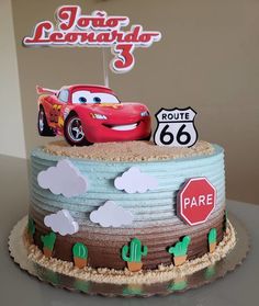 a birthday cake with cars on it and a sign that says route 66 in spanish