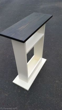 a white and black table sitting on top of a parking lot