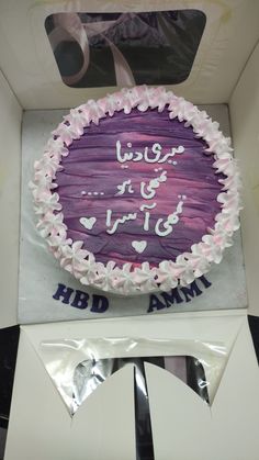 a purple cake with white frosting in a box