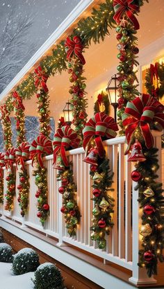 christmas decorations are hanging on the balcony railings and decorated with red, green and gold bows