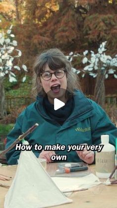 a woman sitting at a table in front of a laptop computer with the words how to make your very own