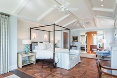 a bedroom with white walls and wood floors