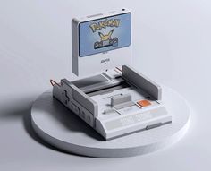 an old nintendo game console sitting on top of a white plate with a pokemon sticker