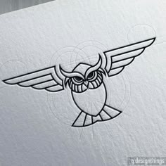 an owl with big eyes and large wings on it's head is drawn in black ink