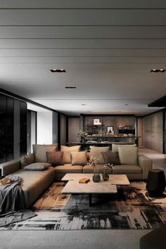 a living room with couches, tables and lamps on the ceiling is lit by recessed lights