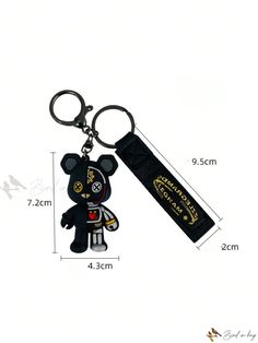 a keychain with a black bear on it and a tag attached to it