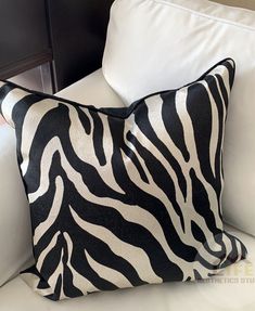 a zebra print pillow on a white couch