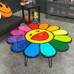 a colorful flower shaped coffee table in a living room