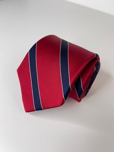 "Tommy Hilfiger Red and Blue necktie Length: 58\" Width: 3.25\" Material: 100% Silk" Dapper Semi-formal Red Tie, Dapper Red Tie For Semi-formal Occasions, Dapper Red Suit And Tie Accessories For Formal Occasions, Dapper Red Suit And Tie Accessories For Formal Events, Red Standard Tie, Red Standard Tie For Formal Occasions, Classic Red Suit And Tie Accessories For Business, Red Business Tie, Classic Red Neckwear With Ties