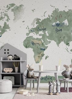 a child's room with a world map painted on the wall and stuffed animals