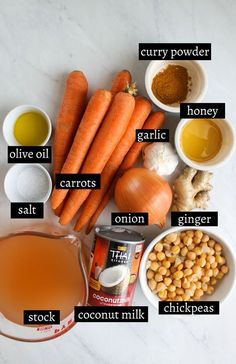 carrots, onions, chickpeas, and other ingredients on a white table