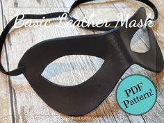 a black masquerade with the words basic leather mask on it's side