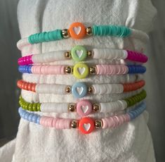 ALL BRACELETS ARE SOLD INDIVIDUALLY   These colorful  personalized bracelets are perfect to add to any bracelet set that you might have or even to wear by themselves. They are made up of colorful glass and heishi beads.  HEART BEADS: purple, blue, green, pink, yellow, red, orange  SIDE HEISHI BEADS: if one is not picked, i'll bead white on the sides  PRODUCT DETAILS  Bracelets are strung on high quality stretchy cord.Easy to roll on your hand and take off.  -Closure:tie LENGTH:  You can referenc Cheap White Wristband With Colorful Beads, Cheap White Braided Bracelet With Colorful Beads, Kids Charm Bracelet, Bracelet Keychains, Tie Length, Bachelorette Party Favors, Bracelets Handmade Beaded, Stretchy Bracelets, Heishi Beads