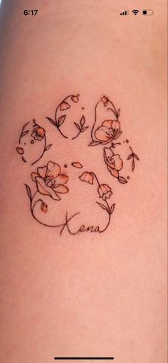 a woman's thigh with flowers on it and the word love written in cursive writing