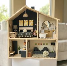 a doll house with furniture and decor inside