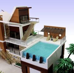 an aerial view of a house with a swimming pool in the front yard and stairs to the second floor