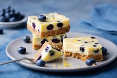 three pieces of cheesecake with blueberries on a plate