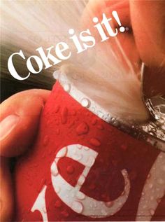 a person holding a can of coke in their hand with the caption coke is it