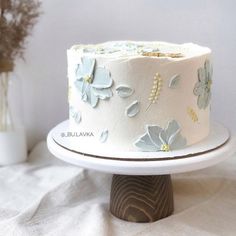 there is a white cake with blue flowers on it