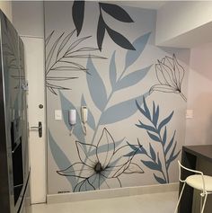 an artisticly painted wall in a modern kitchen