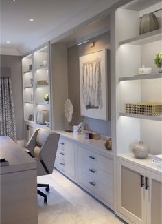 an office with white furniture and shelves filled with vases